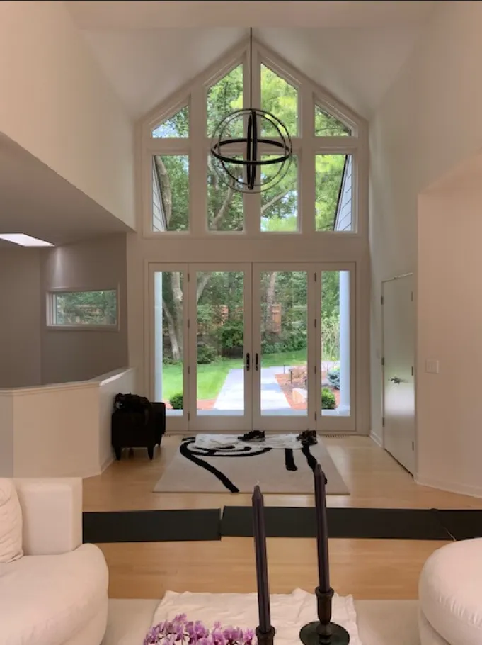 Light-filled entry with tall windows and strong vertical volume.